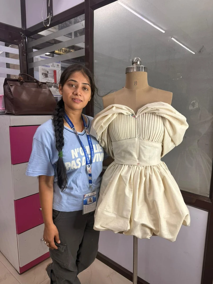 Wisdom College student with couture garment on mannequin